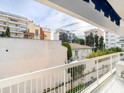 a balcony with a white railing and buildings at Beautiful Apartment with Balcony 1BR 2P - Cannes in Cannes