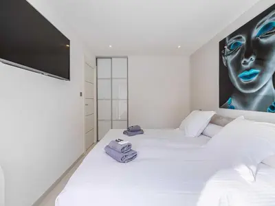 a bedroom with a white bed with towels on it at Beautiful Apartment with Balcony 1BR 2P - Cannes in Cannes