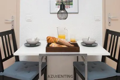 a table with a tray of bread and orange juice at Studio plage et palais Cannes meynadier 1 in Cannes