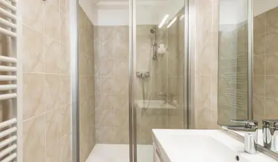 a bathroom with a shower and a white sink at Studio plage et palais Cannes meynadier 1 in Cannes