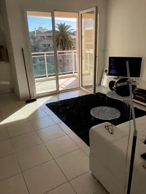 a living room with a couch and a table at Centre Cannes Bristol in Cannes
