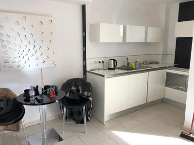 a small kitchen with a table and a table and chairs at Centre Cannes Bristol in Cannes