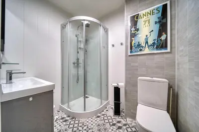 a bathroom with a shower and a toilet and a sink at REF 1413 - Cannes Center Appartment for rent in Cannes