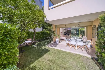 a patio with a table and chairs in a yard at REF 1413 - Cannes Center Appartment for rent in Cannes