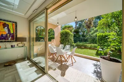 a dining room with a table and a large window at REF 1413 - Cannes Center Appartment for rent in Cannes