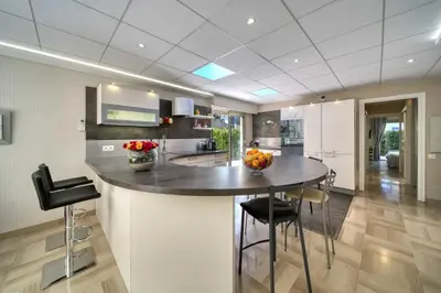 a kitchen with a large island in the middle at REF 1413 - Cannes Center Appartment for rent in Cannes