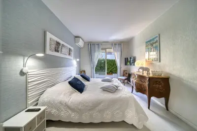 a bedroom with a bed and a dresser and a desk at REF 1413 - Cannes Center Appartment for rent in Cannes