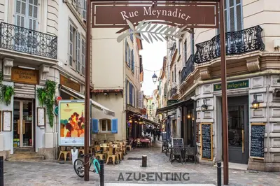 a street in a city with tables and chairs at Cozy Studio Cannes 2 min Croisette & Palais 3 in Cannes