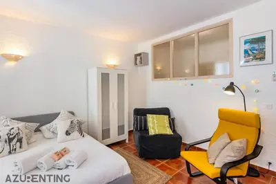 a bedroom with a bed and a yellow chair at Cozy Studio Cannes 2 min Croisette & Palais 3 in Cannes
