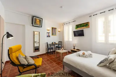 a bedroom with a bed and a living room at Cozy Studio Cannes 2 min Croisette & Palais 3 in Cannes