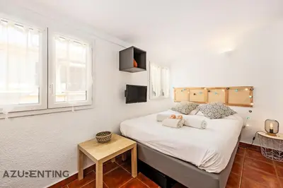 a bedroom with a large bed with white sheets at Cozy Studio Cannes Plage Croisette 4 in Cannes