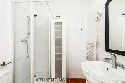 a white bathroom with a sink and a shower at Cozy Studio Cannes Plage Croisette 4 in Cannes