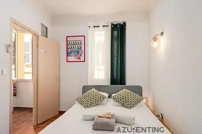 a bed with two pillows on it in a room at Studio lumineux au cœur de Cannes 2 in Cannes