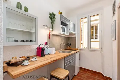 a kitchen with a wooden counter and a sink at Studio lumineux au cœur de Cannes 2 in Cannes