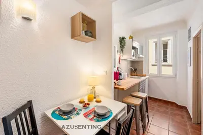 a kitchen and dining room with a table and chairs at Studio lumineux au cœur de Cannes 2 in Cannes