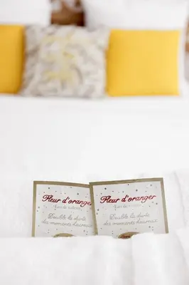 two cards on top of a bed with at Good Vibes - 10mn from harbor, 5mn from Palais and train station, central, AC, comfy in Cannes