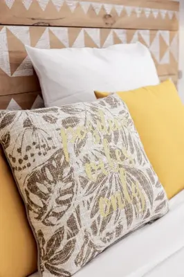 a pillow sitting on top of a bed at Good Vibes - 10mn from harbor, 5mn from Palais and train station, central, AC, comfy in Cannes