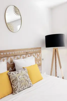 a bedroom with a bed with a mirror on the wall at Good Vibes - 10mn from harbor, 5mn from Palais and train station, central, AC, comfy in Cannes