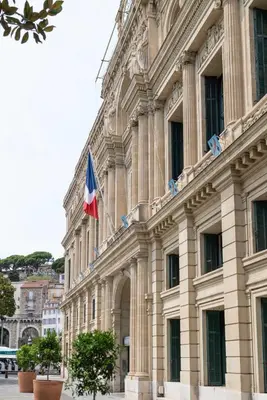 a building with a flag on top of it at NEW Le Backstage Croisette et Plages à 5 min Cannes Lifestyle Central Stay OFFRE SPECIALE in Cannes