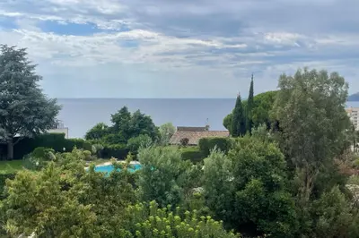 a garden with a swimming pool and trees at Escape in Cannes sea view and shared pool! in Cannes