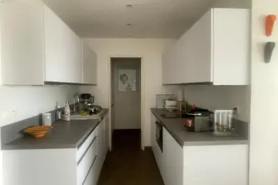 a kitchen with white cabinets and a counter top at Escape in Cannes sea view and shared pool! in Cannes
