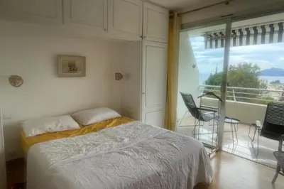 a bedroom with a bed and a balcony at Escape in Cannes sea view and shared pool! in Cannes
