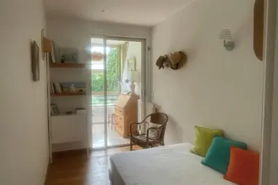 a bedroom with a bed with colorful pillows on it at Escape in Cannes sea view and shared pool! in Cannes