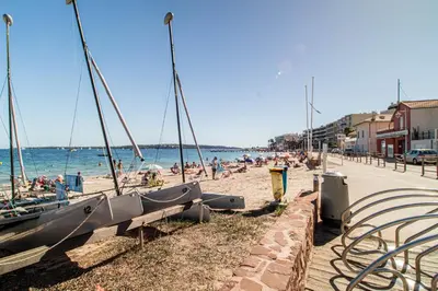 a beach with a boat parked on the sand at Charmant 2p proche des plages, appartement Céladon in Cannes