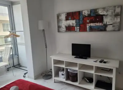 a living room with a desk with a television on it at Centre Cannes Victor Cousin in Cannes