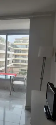 a room with a table and a view of a building at Centre Cannes Victor Cousin in Cannes