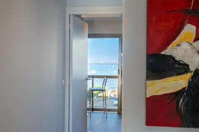 a painting hanging on a wall next to a door at Beautiful 2-Br Apartment Sea View Beaches Within Walking Distance in Cannes