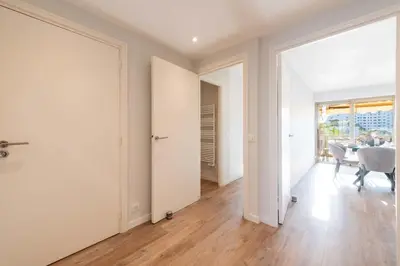 an empty living room with white walls and wooden floors at Beautiful 2-Br Apartment Sea View Beaches Within Walking Distance in Cannes