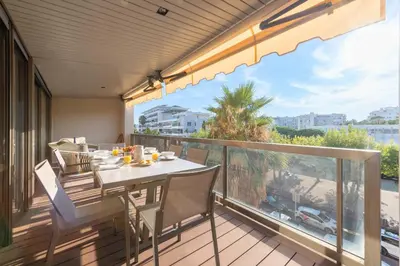 a table and chairs on a balcony with a view at Beautiful 2-Br Apartment Sea View Beaches Within Walking Distance in Cannes