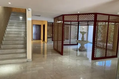 a lobby with a staircase and a gate with a fountain at Apartment for 2 with balcony near beach in Cannes