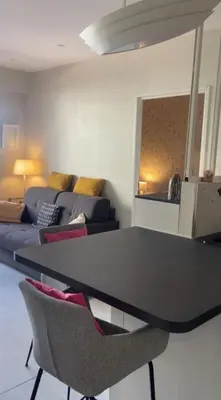 a living room with a table and a couch at Apartment for 2 with balcony near beach in Cannes