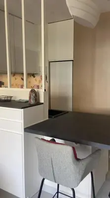 a kitchen with a black counter and a chair at Apartment for 2 with balcony near beach in Cannes