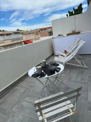 a living room with a couch and a table at Adresse privilège pour les congres in Cannes