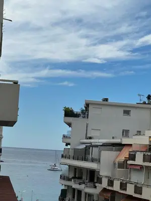 a balcony with a table and a chair on a roof at Adresse privilège pour les congres in Cannes
