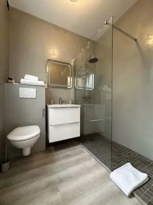 a white bedroom with a mirror and a bed at Adresse privilège pour les congres in Cannes