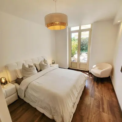 a white bedroom with a large bed and a window at Exceptional 3-room apartment in quiet Cannes in Cannes