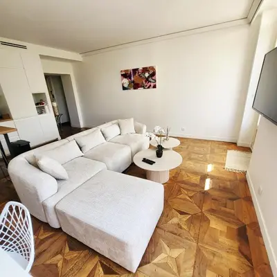 a living room with a white couch and a table at Exceptional 3-room apartment in quiet Cannes in Cannes