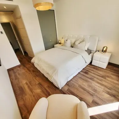 a large white bed in a room with wooden floors at Exceptional 3-room apartment in quiet Cannes in Cannes