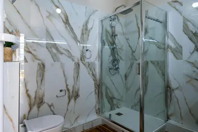 a bathroom with a shower and a toilet at Parthenopi suite, le chic de Cannes dans le centre, près du palais in Cannes