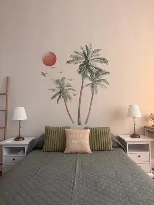 a bedroom with a bed with two palm trees on the wall at Parthenopi suite, le chic de Cannes dans le centre, près du palais in Cannes