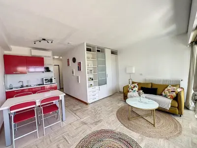a living room with a couch and a table at Le 65 Picaud - Superbe logement proche plages in Cannes