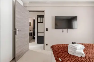 a bedroom with a bed with towels on it at LX169 Design lumineux a deux pas de la Croisette in Cannes