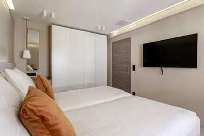a bedroom with a bed and a flat screen tv at LX169 Design lumineux a deux pas de la Croisette in Cannes