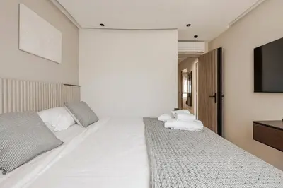 a bedroom with two beds and a flat screen tv at LX169 Design lumineux a deux pas de la Croisette in Cannes