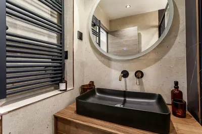 a black sink in a bathroom with a mirror at LX169 Design lumineux a deux pas de la Croisette in Cannes