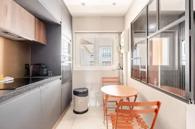 a small kitchen with a table and chairs in a room at LX169 Design lumineux a deux pas de la Croisette in Cannes